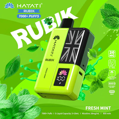 Hayati Rubik vape device on a green background with fresh mint leaves